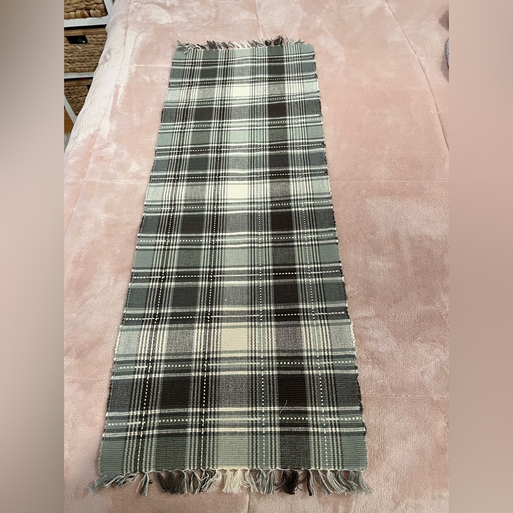 Table runner, gray and white size with fringe is 38” long x 13” wide